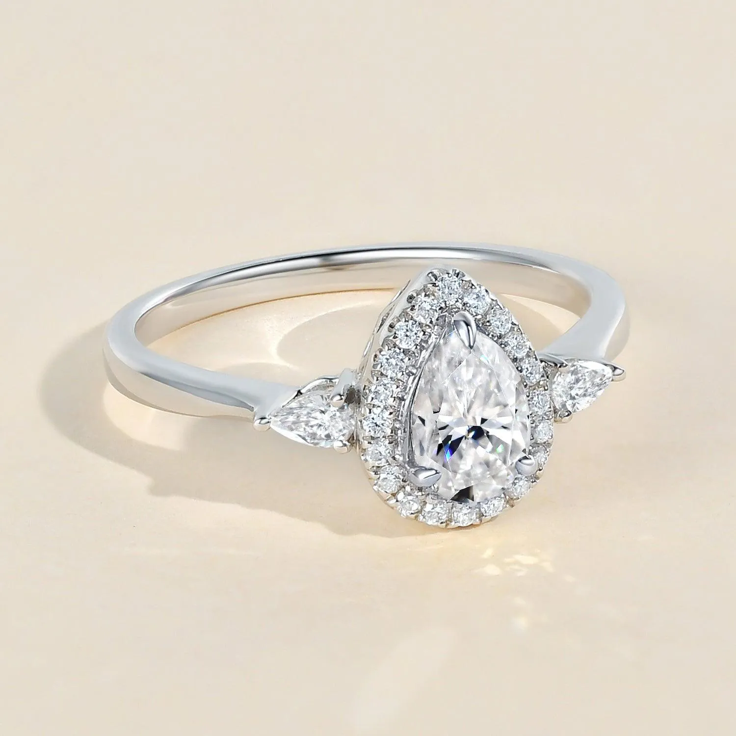 1.0ct Pear Shaped Moissanite Three-Stone Halo Ring